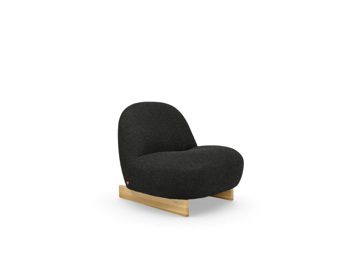 urbane EQ3 Arlo chair featuring dark grey nubby bouclé fabric and a solid oak sled base in a compact design.