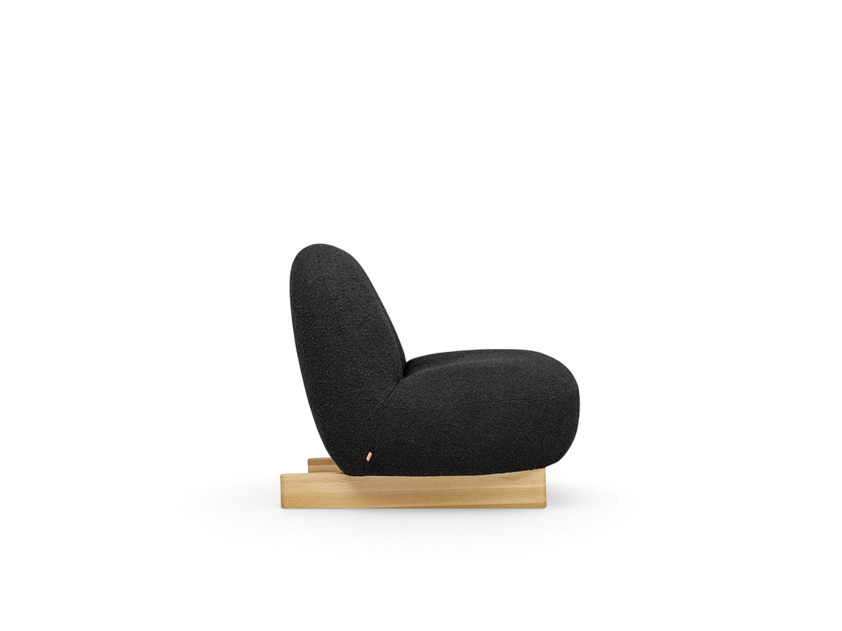 urbane EQ3 Arlo chair in black bouclé fabric with a solid oak sled base, side view