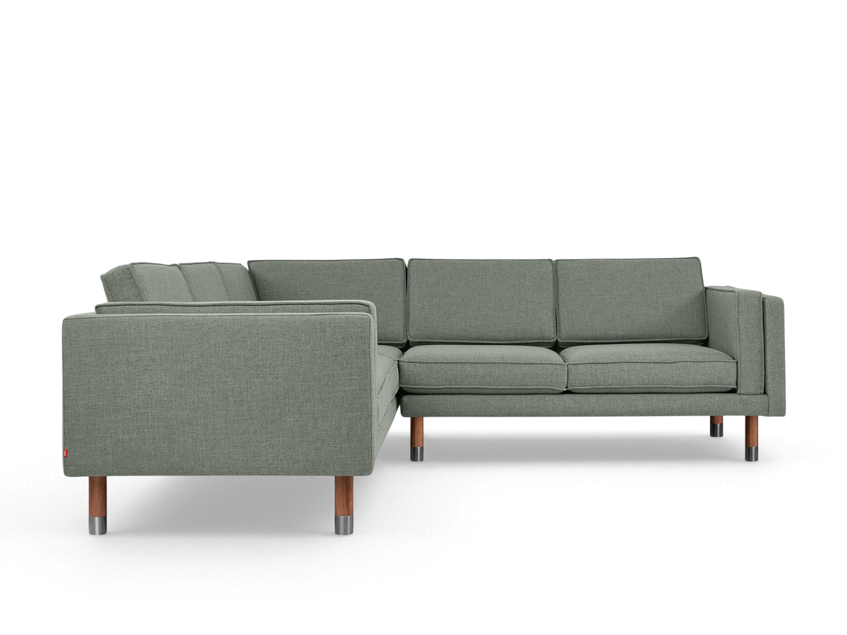 urbane EQ3 Augusta Bi-Sectional sofa in grey fabric with mid-century modern wood and metal legs