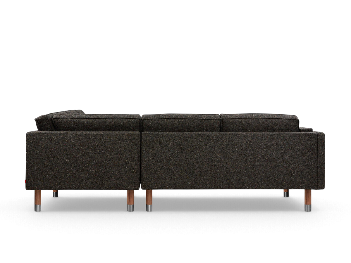 urbane EQ3 Augusta bi-sectional sofa in dark textured fabric with wooden legs and metal accents, back view