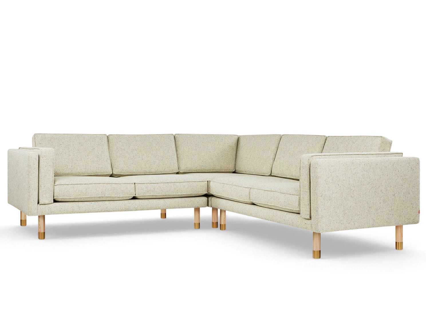 urbane EQ3 Augusta bi-sectional sofa in light textured fabric with natural ash and brass legs on a white background