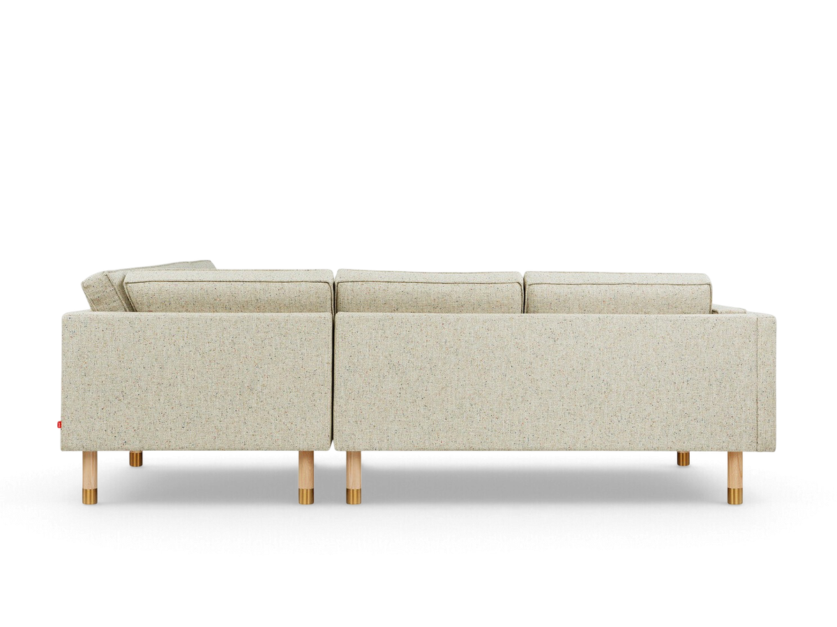 urbane EQ3 Augusta bi-sectional sofa in light textured fabric with natural wood legs and brass accents, back view
