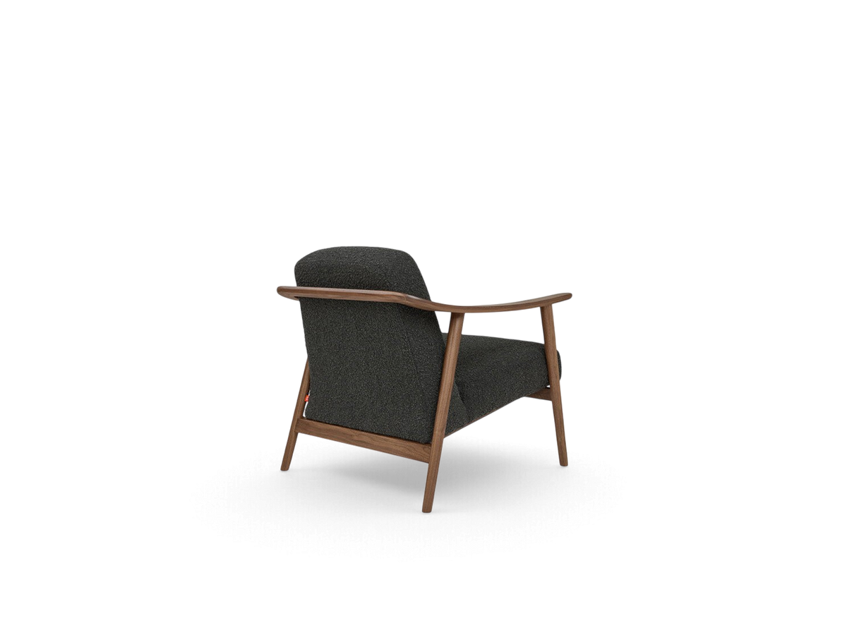urbane EQ3 Baltic Chair with a dark grey upholstered seat and a sculptural solid walnut wood frame, rear view.