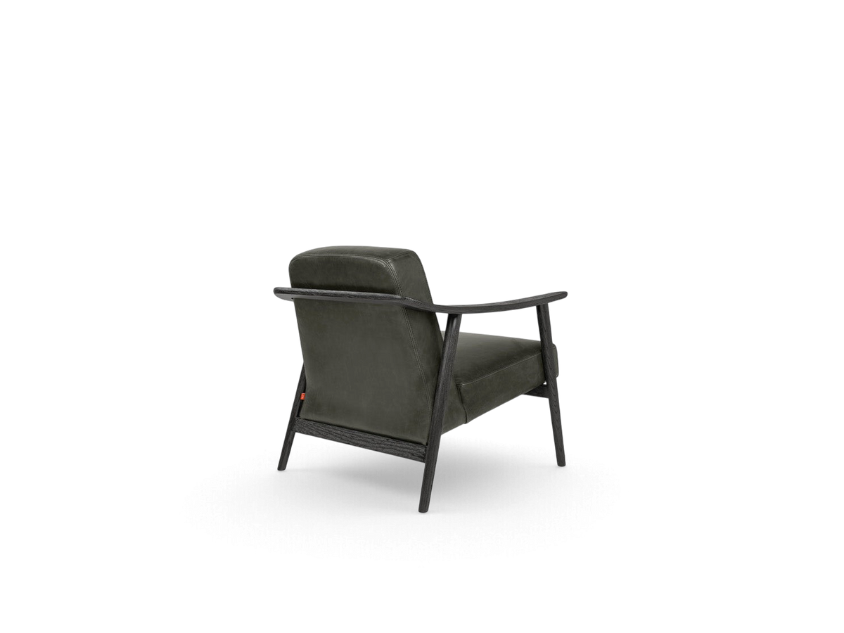 urbane EQ3 Baltic Chair in dark grey upholstery with a sculptural solid wood frame, viewed from the back