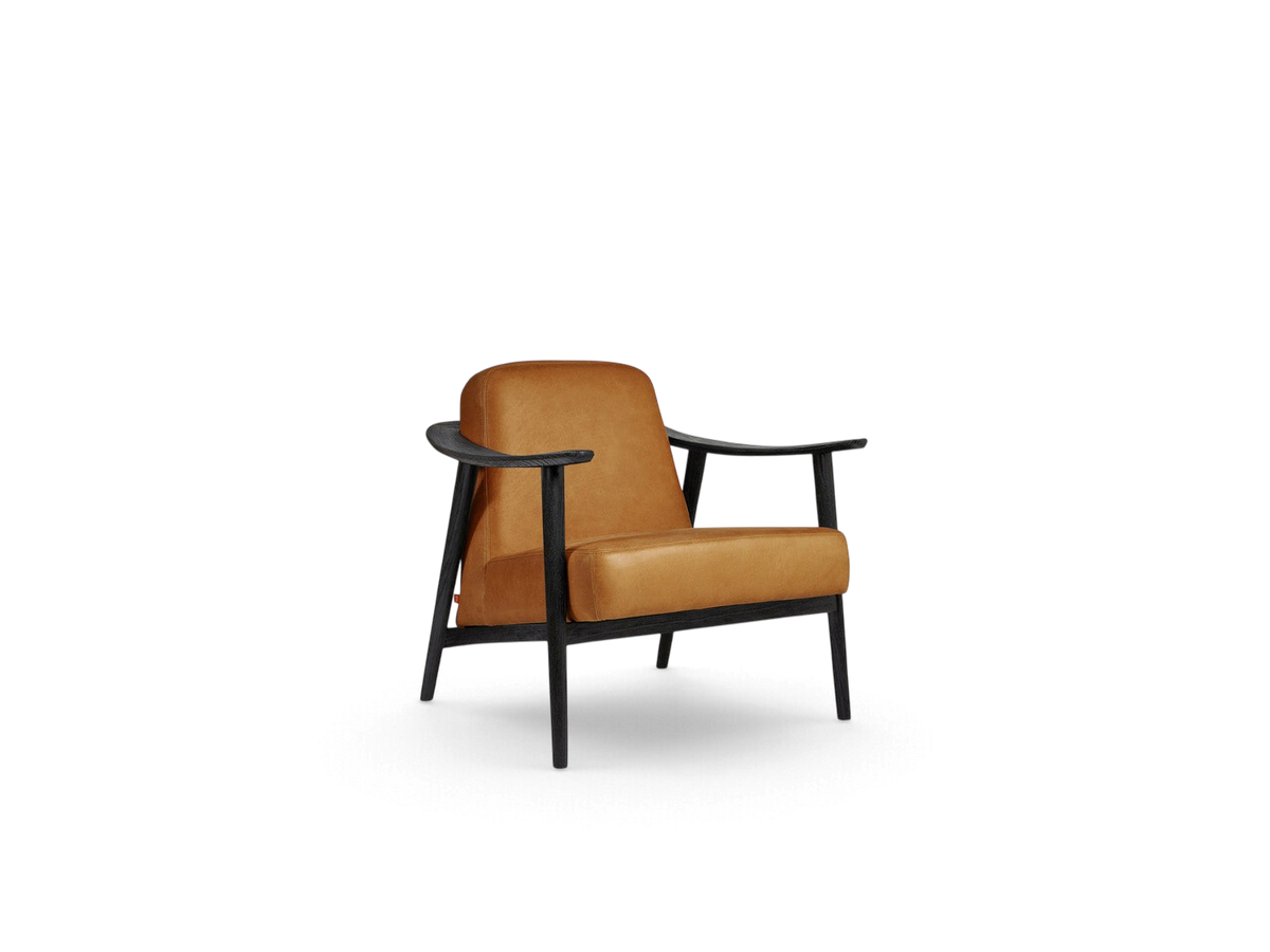 urbane EQ3 Baltic Chair featuring a tan leather seat and a sculptural black solid wood frame in a minimalist style.