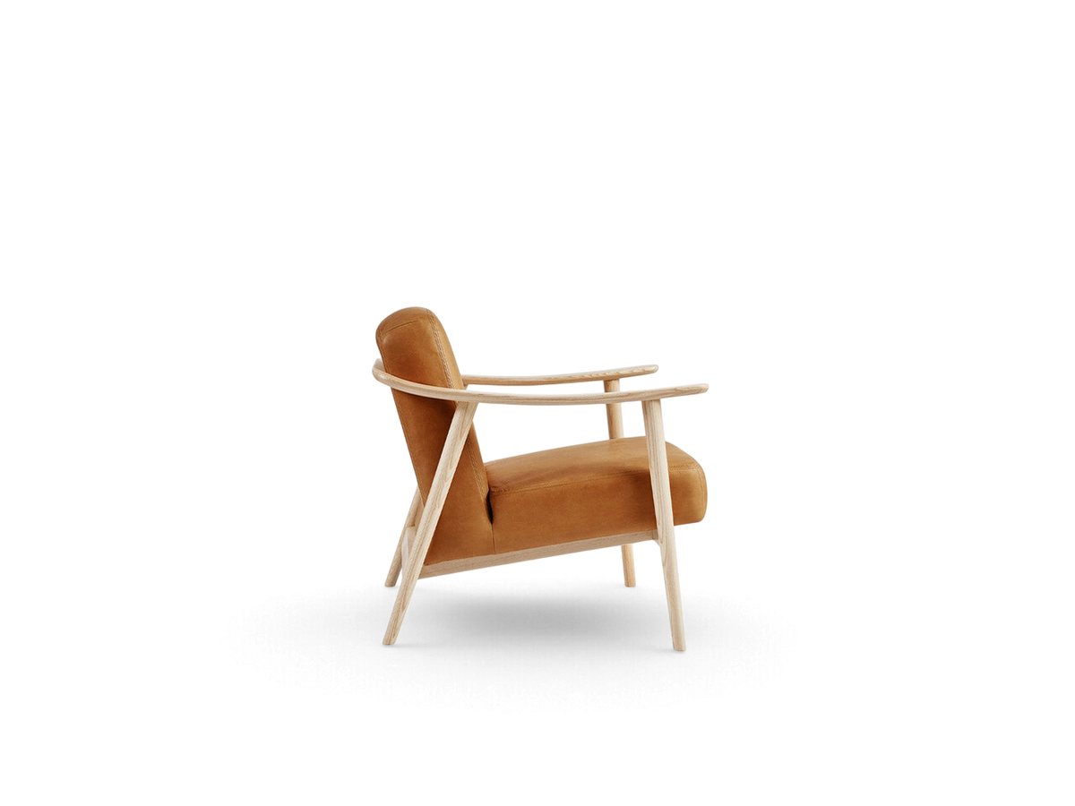 urbane EQ3 Baltic Chair with a light wood frame and tan upholstered seat in a minimalist Nordic style side view