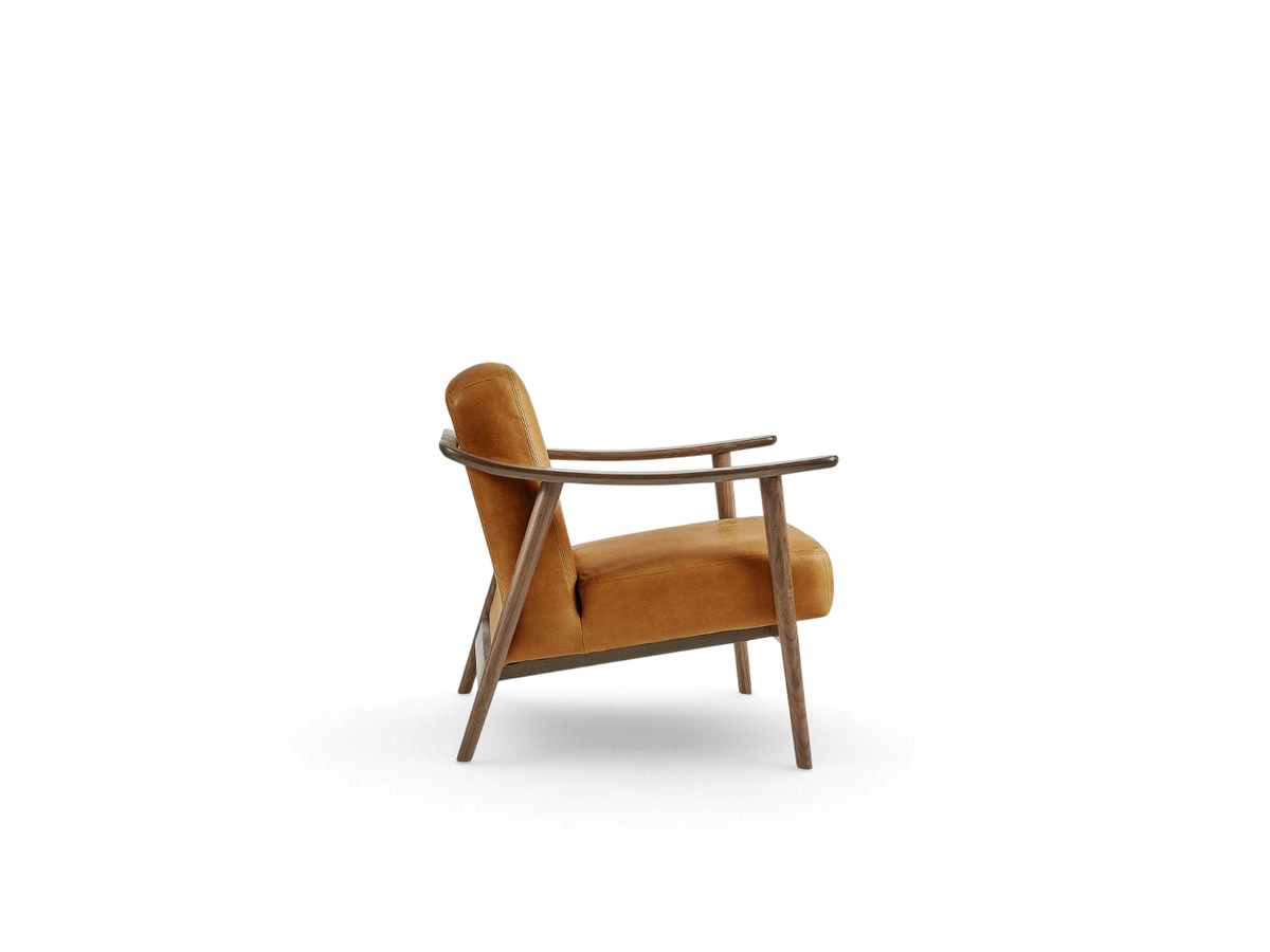 urbane EQ3 Baltic Chair in warm ochre upholstery with a sculptural solid walnut wood frame, side profile view