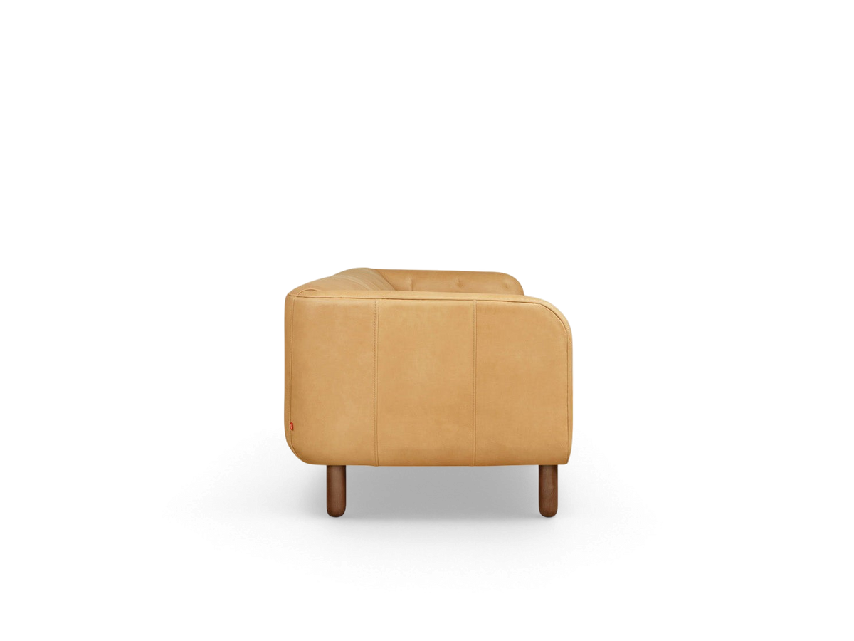urbane EQ3 Beaconsfield sofa in tan top grain leather, side view showing tuxedo frame and walnut stained wood legs