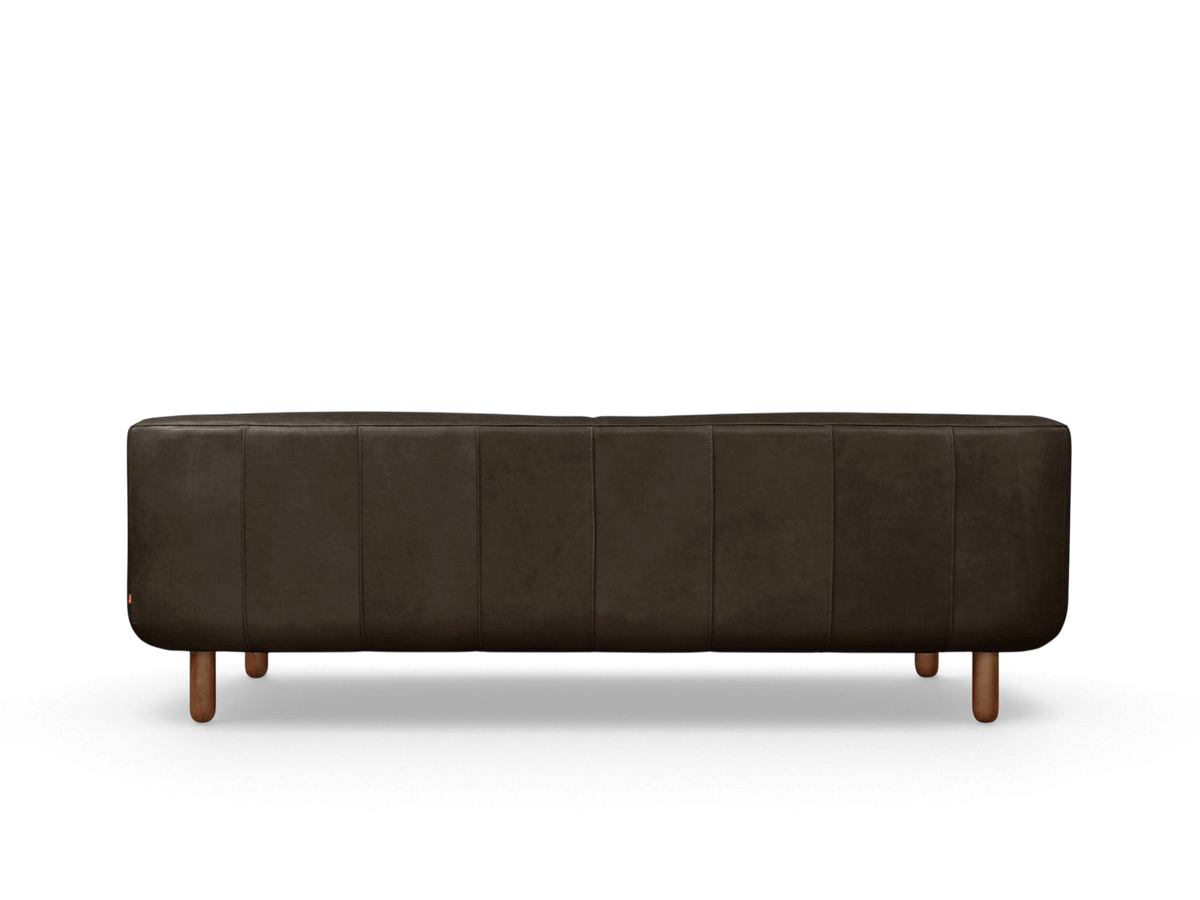 urbane EQ3 Beaconsfield sofa in dark brown top grain leather with blind-tufted detailing and walnut stained wood legs