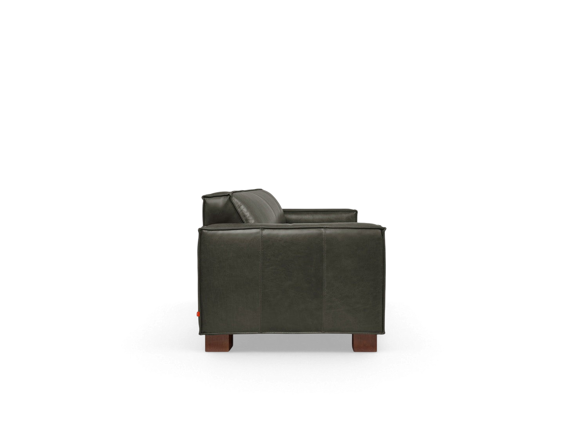urbane EQ3 Cabot Sofa in dark vintage leather with French seam detailing and walnut stained block feet, side view
