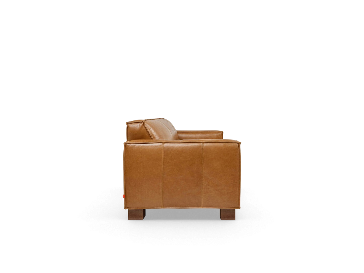 urbane EQ3 Cabot sofa in tan top grain leather with French seam detailing and walnut stained wood block feet