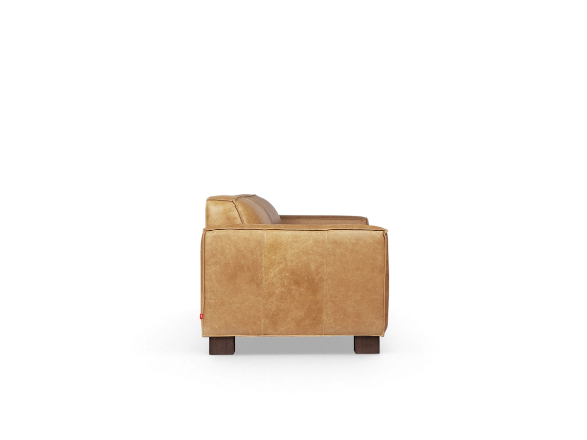 urbane EQ3 Cabot sofa in tan top grain aniline leather with French seam detailing and walnut stained block feet