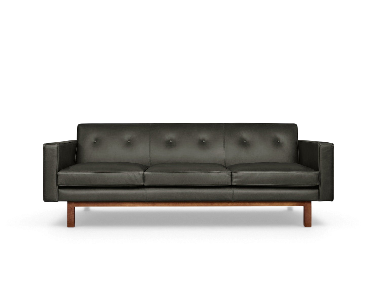 urbane EQ3 Embassy Sofa in dark leather with button-tufted back and solid walnut wood base