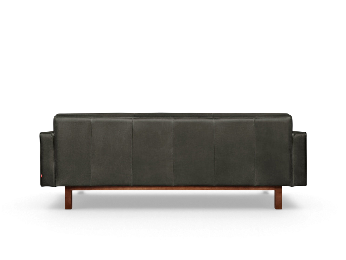 urbane EQ3 Embassy Sofa in dark leather with a mid-century modern design and a solid walnut-stained wood base.