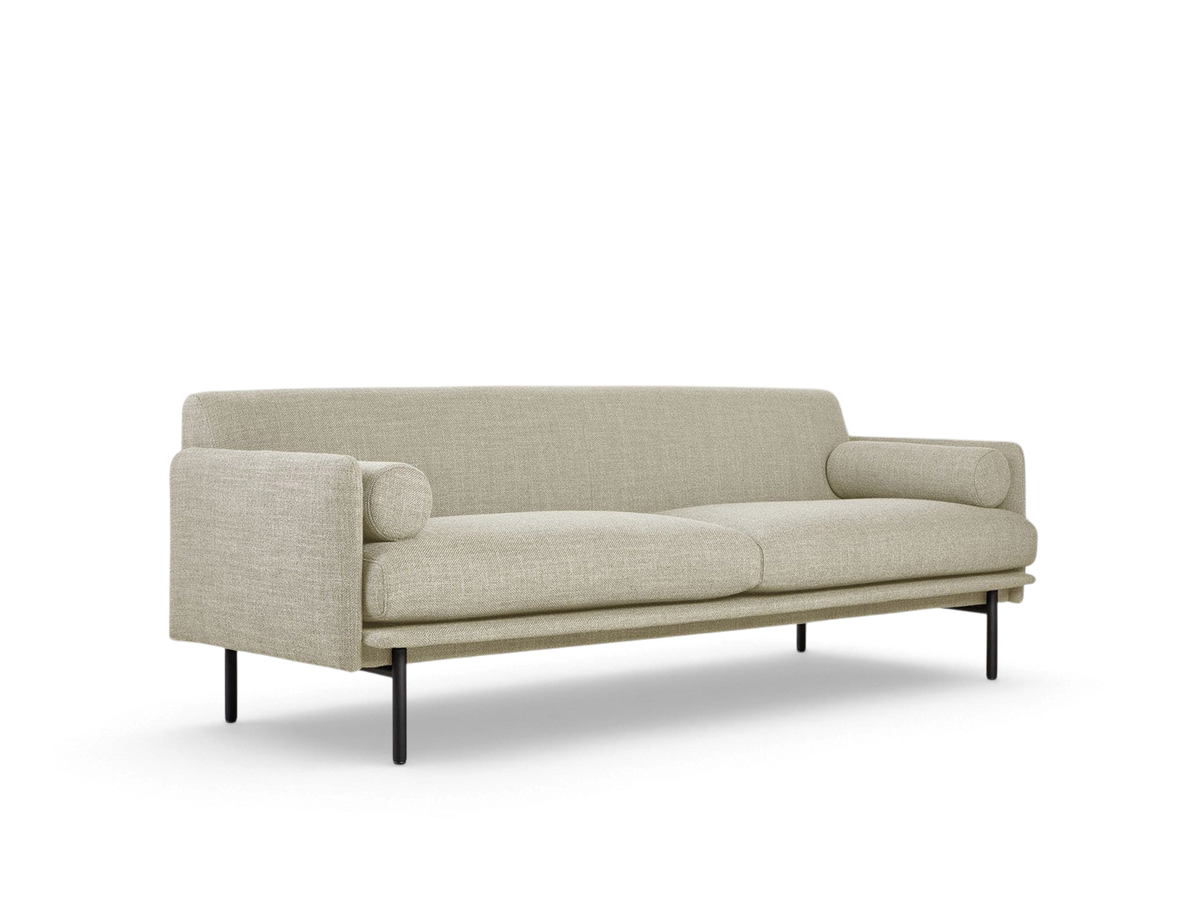 urbane EQ3 Foundry Sofa in light beige fabric with two bolster cushions and black steel legs in a minimalist style