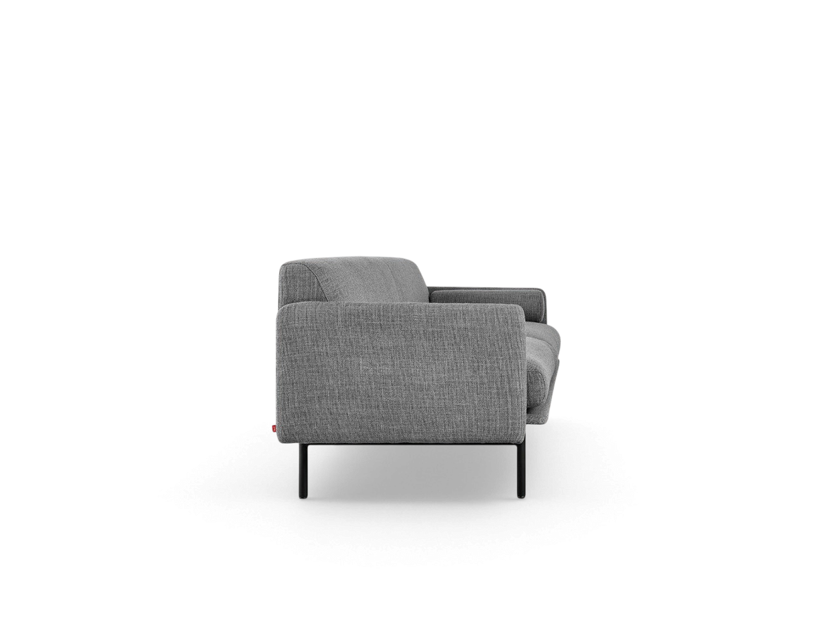 urbane EQ3 Foundry Sofa in grey fabric with a slim tightback frame and black cylindrical steel legs, side view.