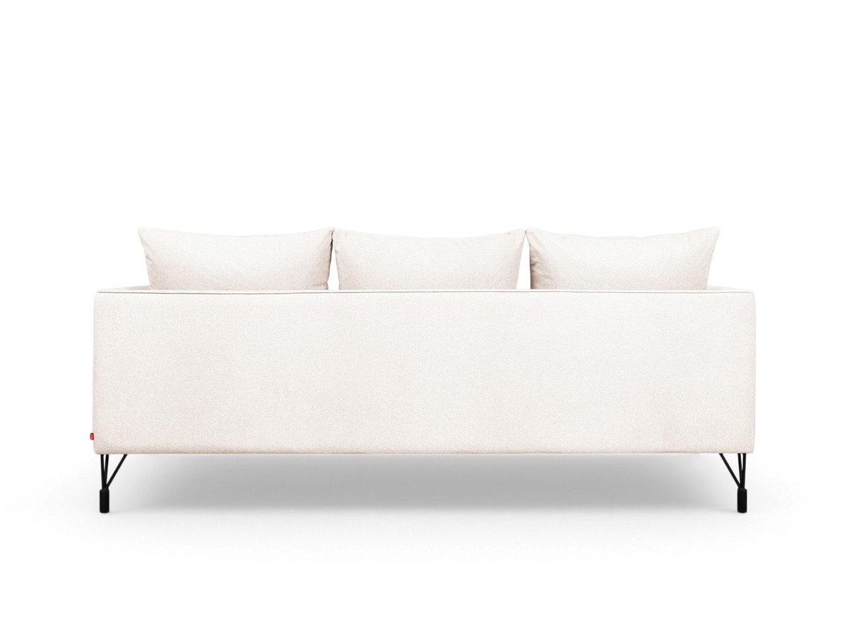 Back view of the urbane EQ3 Highline Sofa in light fabric with slim black architectural legs and piped seam detailing.