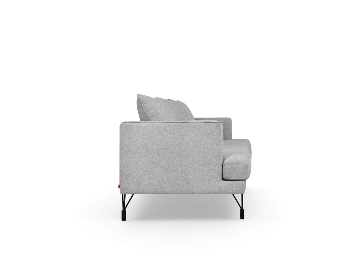 urbane EQ3 Highline Sofa in light grey fabric with slim frame, curved arms, and black architectural metal legs