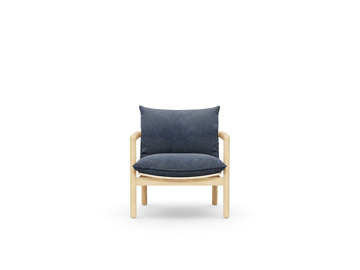 urbane EQ3 Humber Chair with a light wood frame and dark blue upholstered cushions in a minimalist design