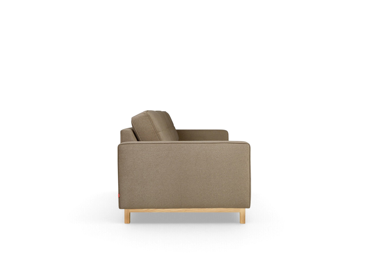 urbane EQ3 Jane 2 sofa in a neutral fabric with a light ash wood base, shown from a side profile view.