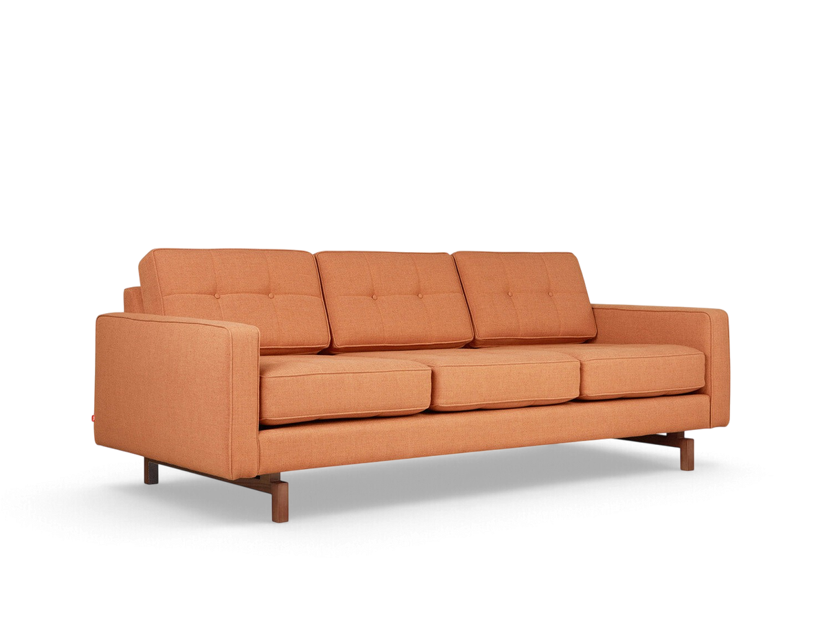 urbane EQ3 Jane 2 sofa in burnt orange fabric with button-tufted cushions and a dark wood inset base