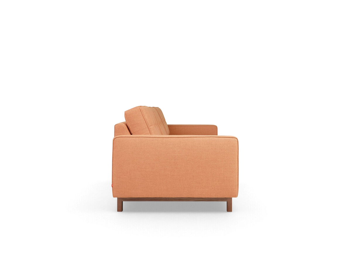 urbane EQ3 Jane 2 sofa in peach fabric with button-tufted cushions and a dark wood base, side profile view