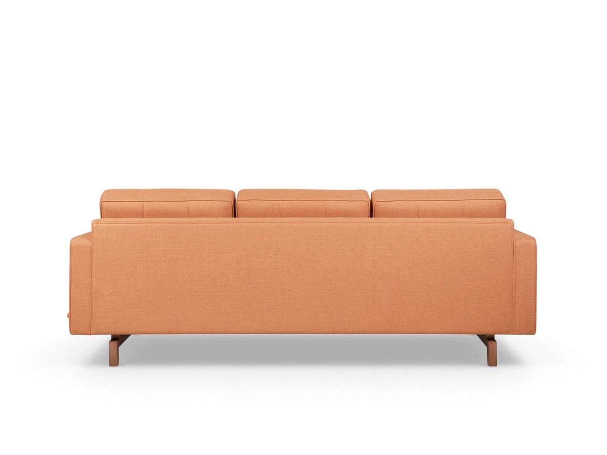 urbane EQ3 Jane 2 sofa in a warm orange fabric with a dark wood base, shown from the back view.