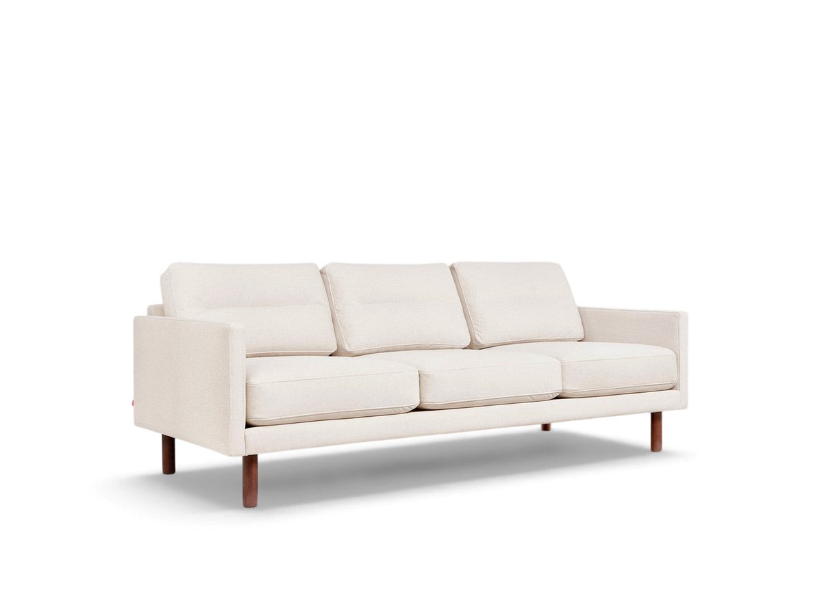 urbane EQ3 Miller sofa in cream fabric with channel-stitched back cushions and walnut-finished solid ash wood legs