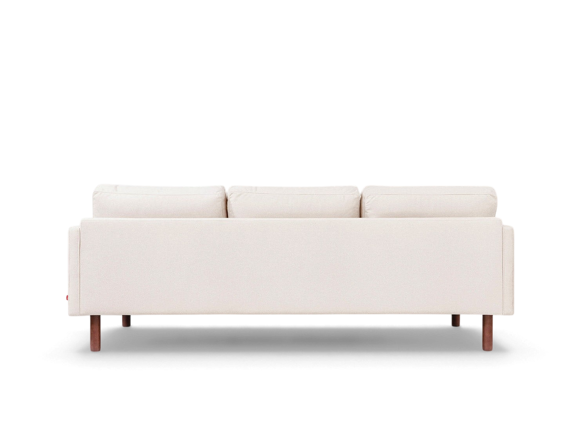 urbane EQ3 Miller sofa in a neutral fabric with channel-stitched back cushions and solid walnut-finished wood legs