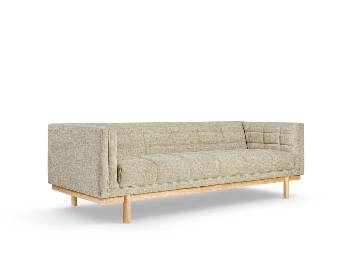 urbane EQ3 Mulholland sofa in light beige fabric with a tuxedo frame, blind-tufting, and solid ash wood base.