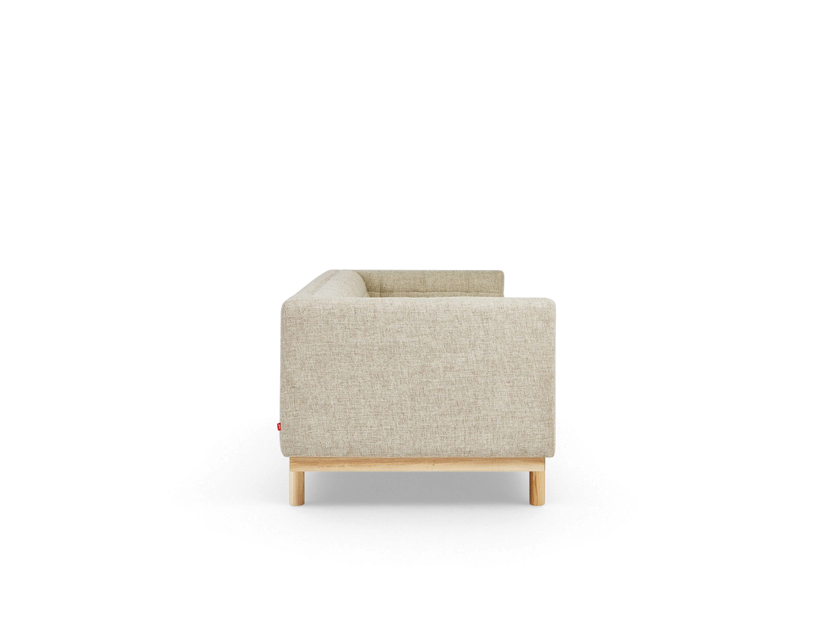 urbane EQ3 Mulholland sofa side view featuring beige fabric upholstery, tuxedo frame, and solid ash wood base