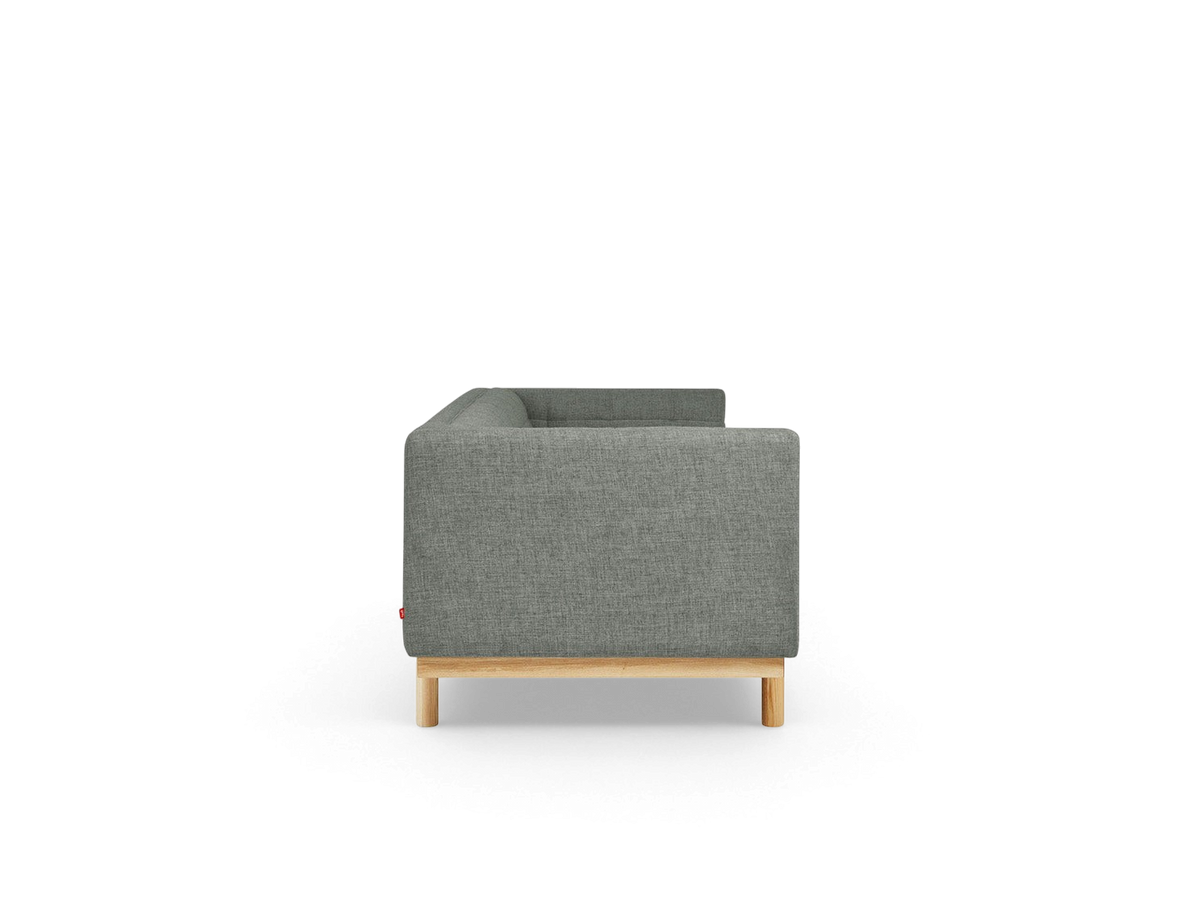 urbane EQ3 Mulholland sofa side view featuring grey tufted upholstery and a solid ash wood base with dowel legs
