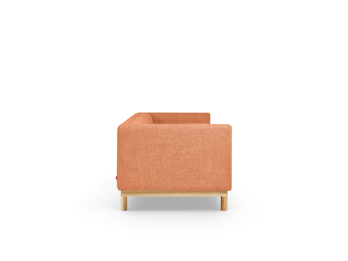 urbane EQ3 Mulholland sofa in orange fabric with a tuxedo frame and solid ash wood base, side view