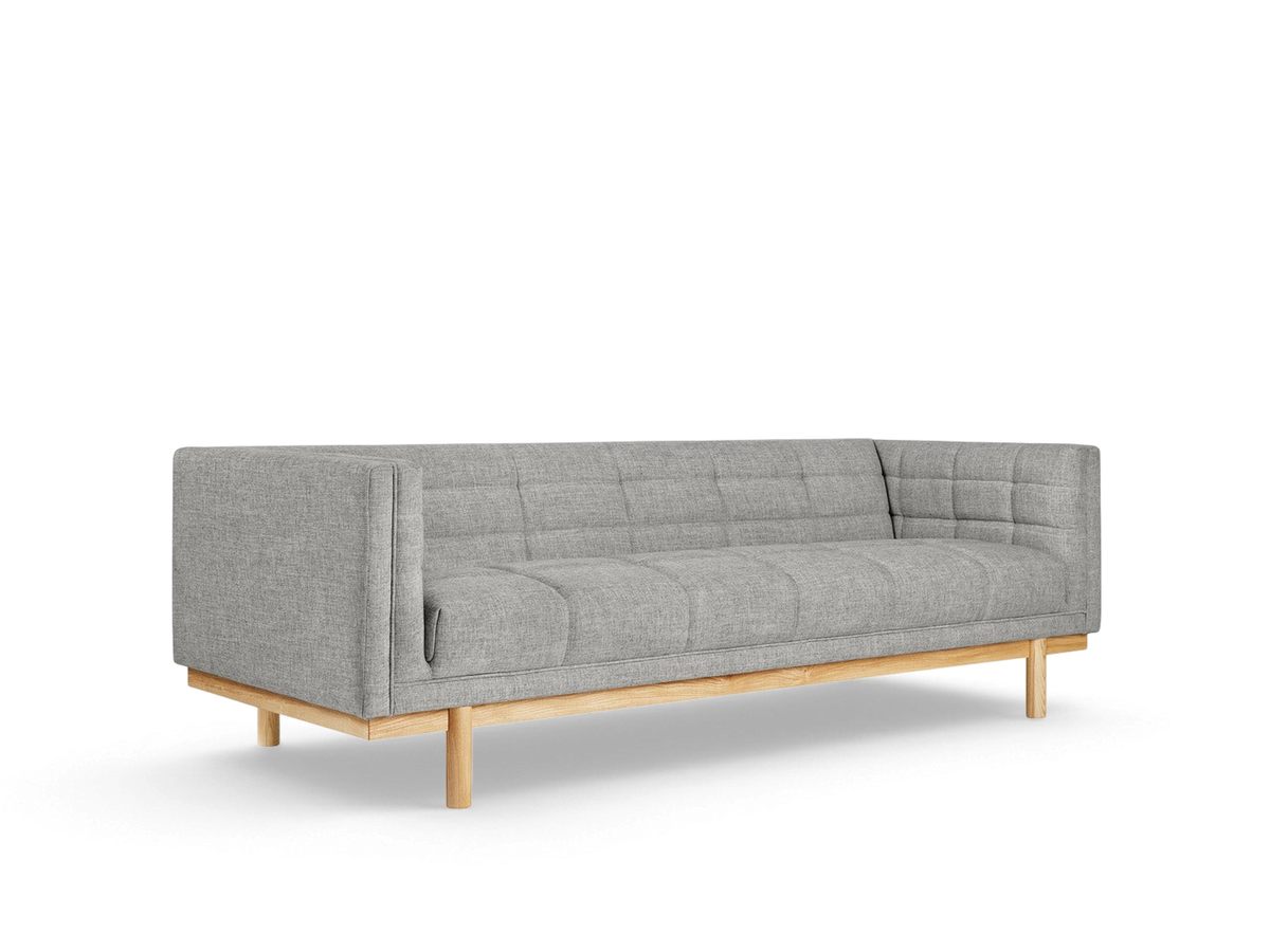 urbane EQ3 Mulholland Sofa in grey fabric with a tuxedo frame, blind-tufting, and a solid ash wood base.