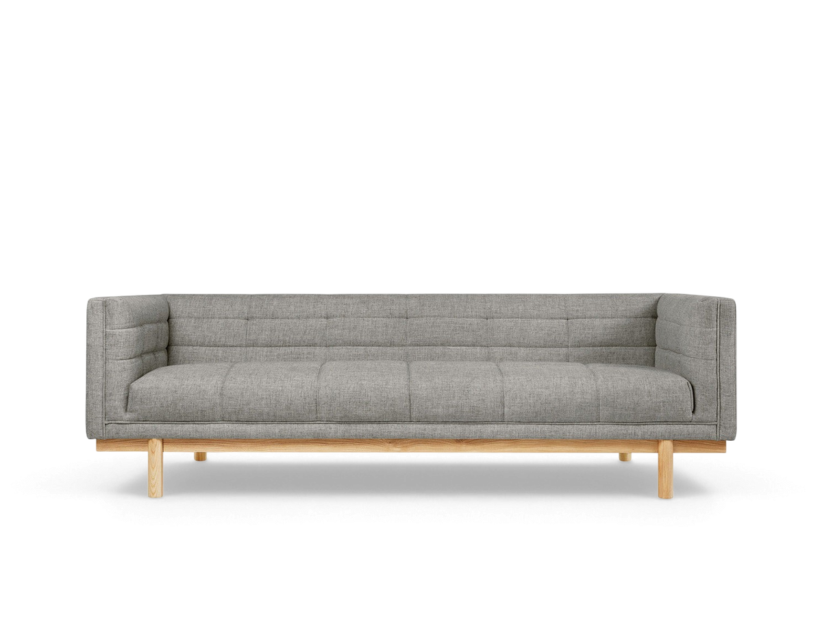 urbane EQ3 Mulholland Sofa in grey fabric with a tuxedo frame, blind-tufting, and a solid ash wood base.