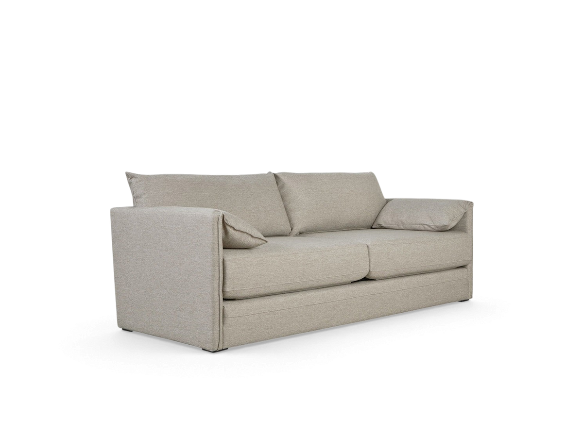 urbane EQ3 Neru Sofabed in light grey fabric with slender arms, feather-filled back cushions, and integrated bolsters.