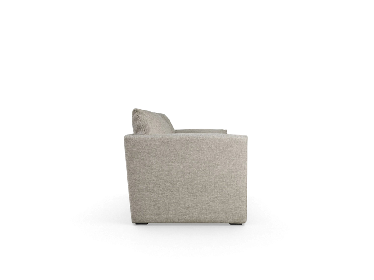 urbane EQ3 Neru Sofabed in light grey fabric with slender arms and French seam detailing, side profile view