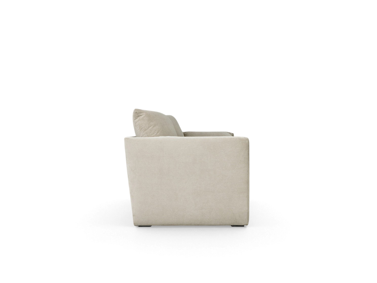 Side view of the urbane EQ3 Neru Sofabed in a neutral fabric, featuring slender arms and French-seam detailing.