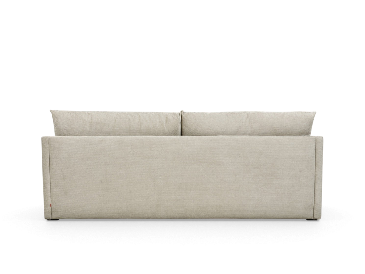 urbane EQ3 Neru Sofabed in a neutral fabric, shown from the back with clean lines and slender arms.