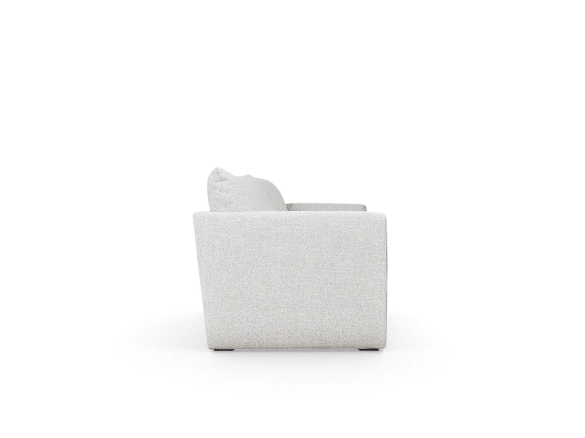 Side view of the urbane EQ3 Neru Sofabed in light grey fabric with slender arms and French seam detailing.