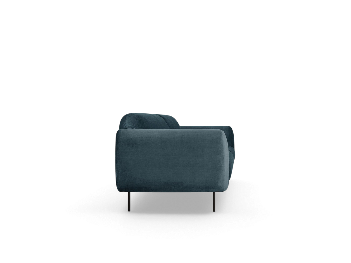 Side view of the urbane EQ3 Nord Sofa in dark blue velvet with black steel legs and a curved retro silhouette.