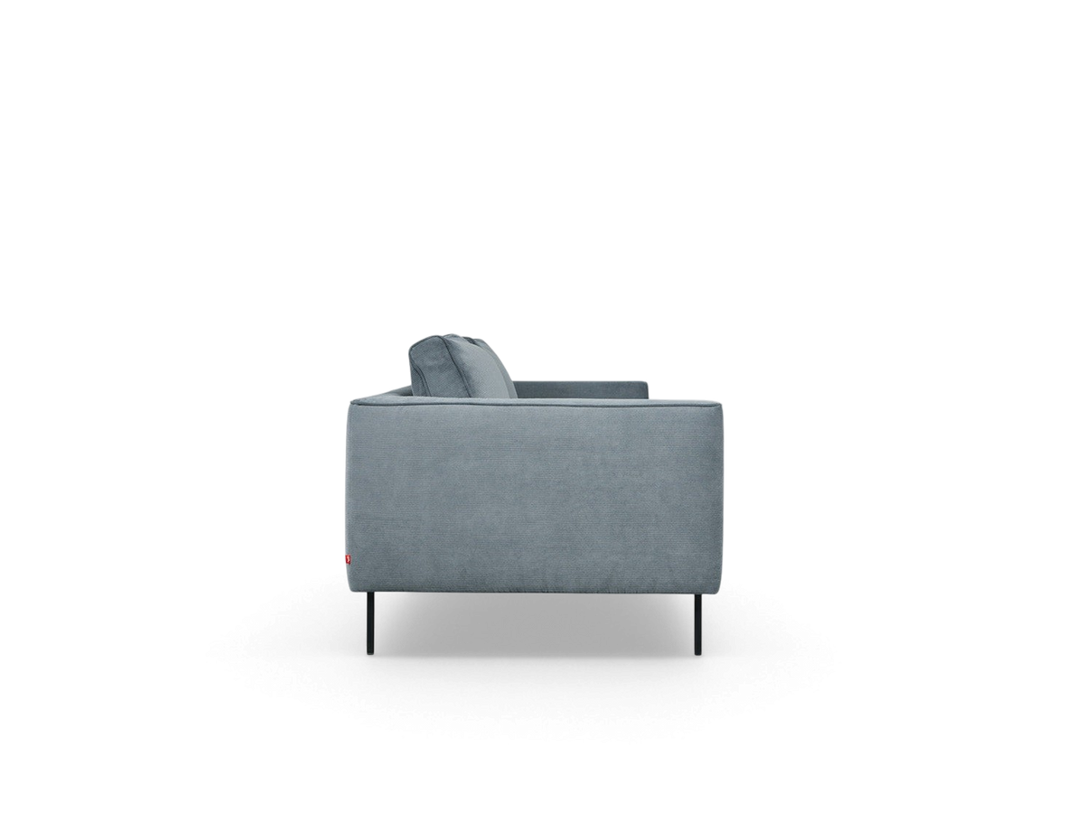 urbane EQ3 Renfrew sofa in blue fabric with a tuxedo frame and black powder-coated steel legs, side view