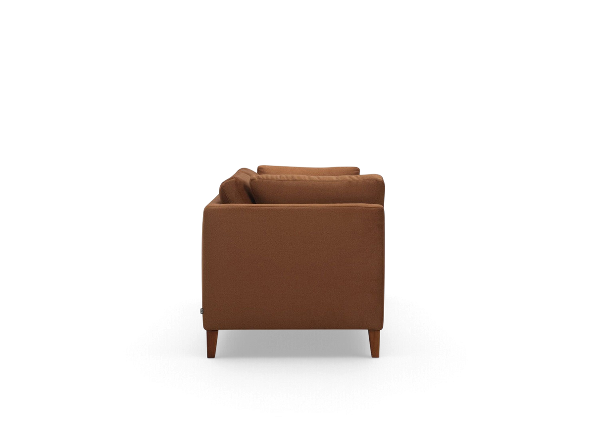 Side profile of the urbane EQ3 Salema 92 inch sofa in a warm brown fabric with tapered wooden legs.