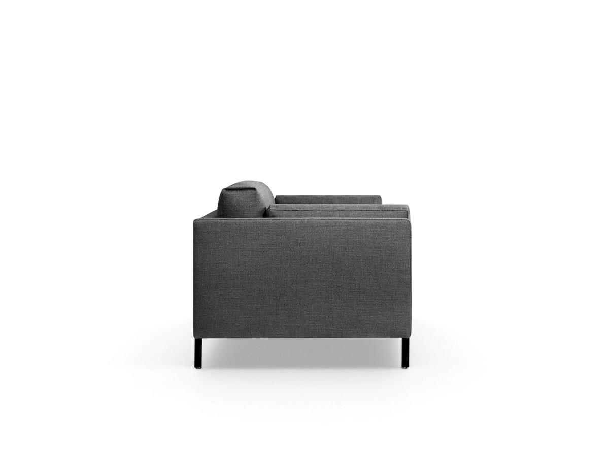 urbane EQ3 Silverlake sofa in dark grey fabric with a tuxedo frame and black steel legs, side profile view.
