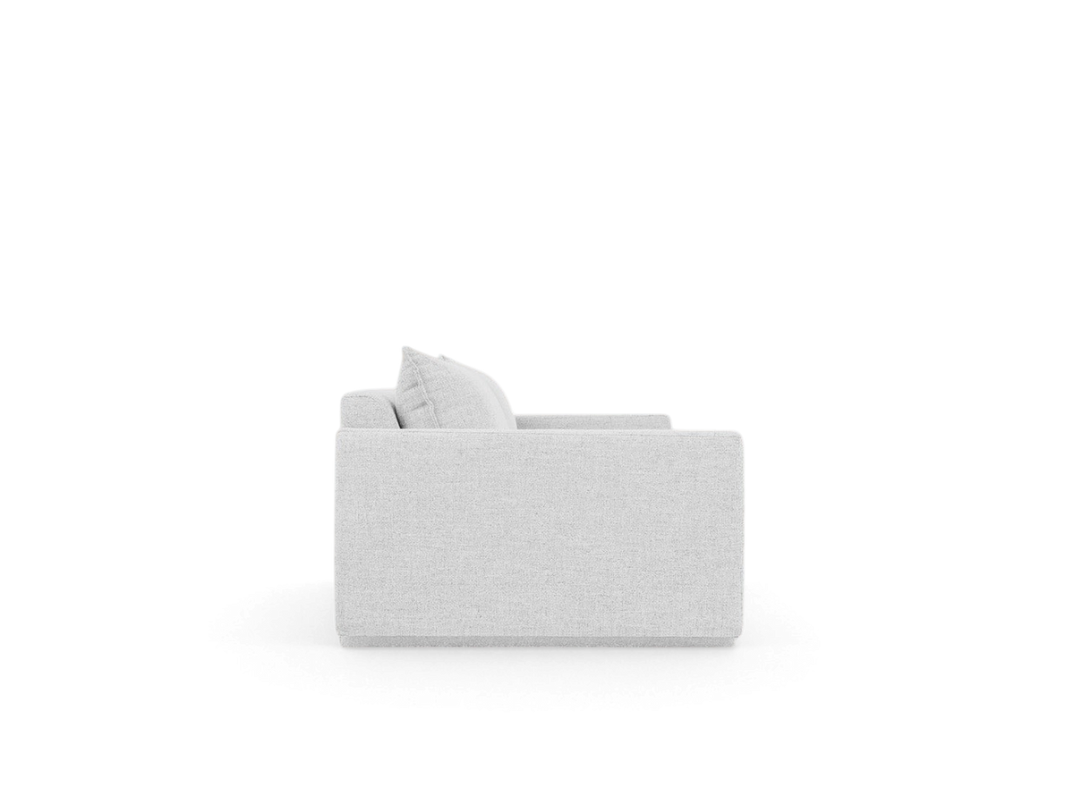 Side profile of the urbane EQ3 Sola Sofa featuring light grey fabric, French-seam detailing, and stepped arm design.