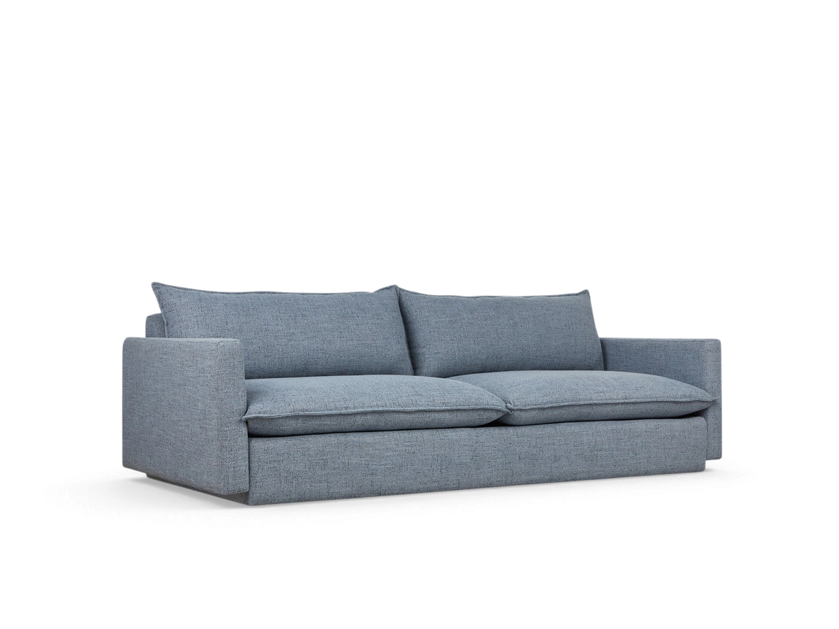 urbane EQ3 Sola Sofa in blue fabric with French-seam detailing and plush cushions on a white background