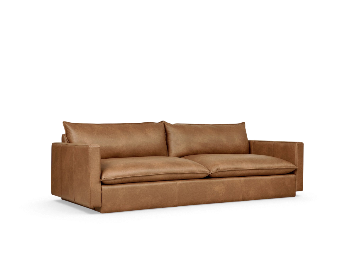 urbane EQ3 Sola Sofa in tan leather with plush cushions, French-seam detailing, and a low-profile contemporary design.