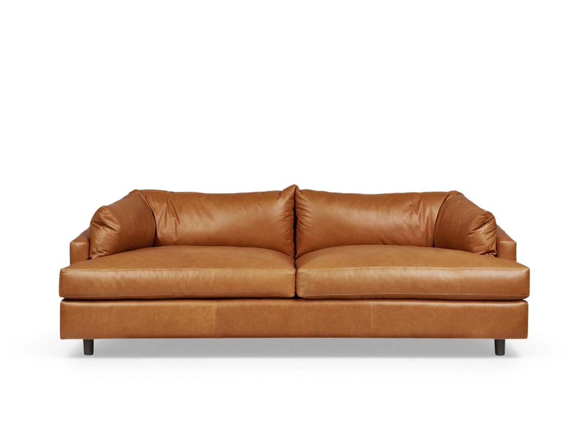 urbane EQ3 Thalia sofa in tan top-grain leather with a 1970s-inspired modern design and wraparound cushions.