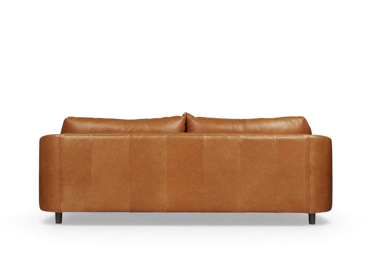 urbane EQ3 Thalia sofa in tan top grain leather with a 1970s Italian modern design and wraparound cushions.