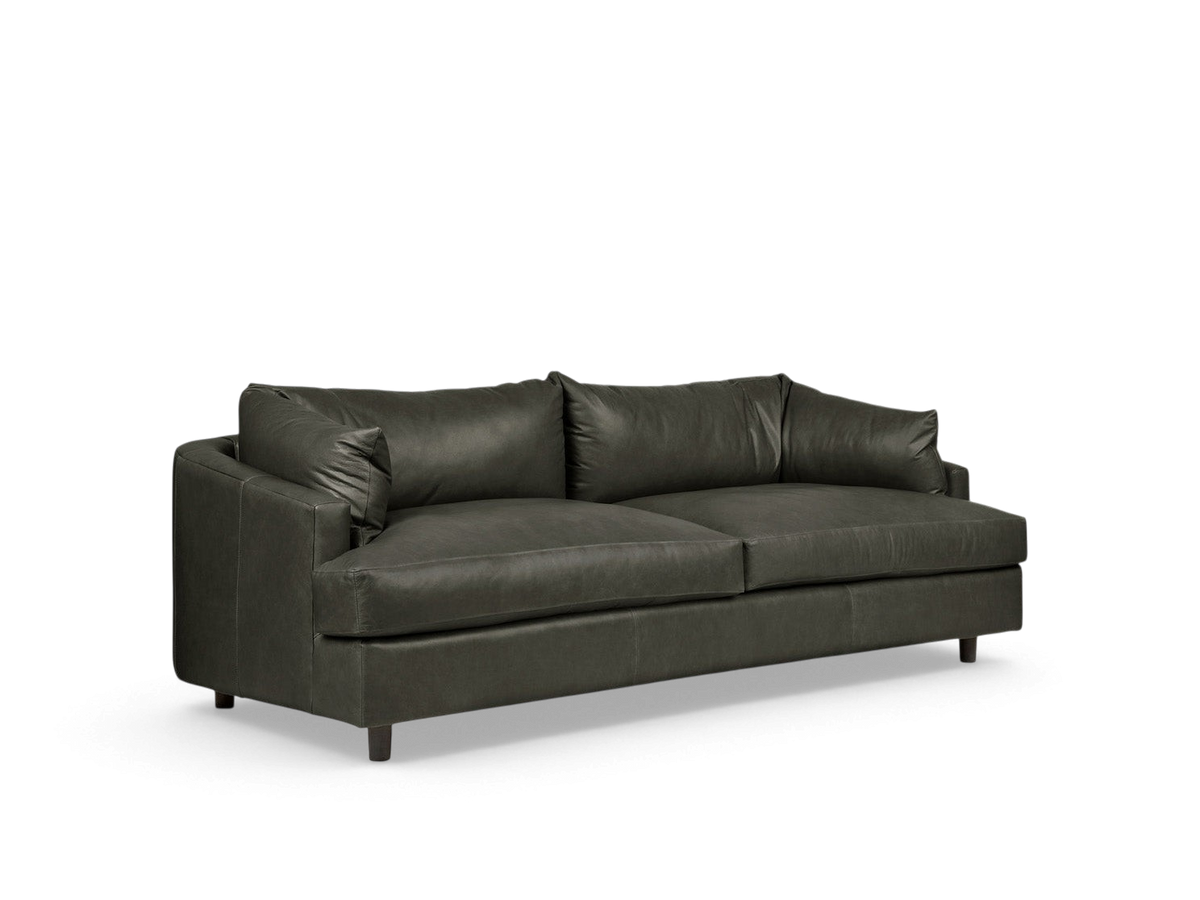 urbane EQ3 Thalia sofa in dark grey top grain leather with a modern 1970s-inspired wraparound cushion design.